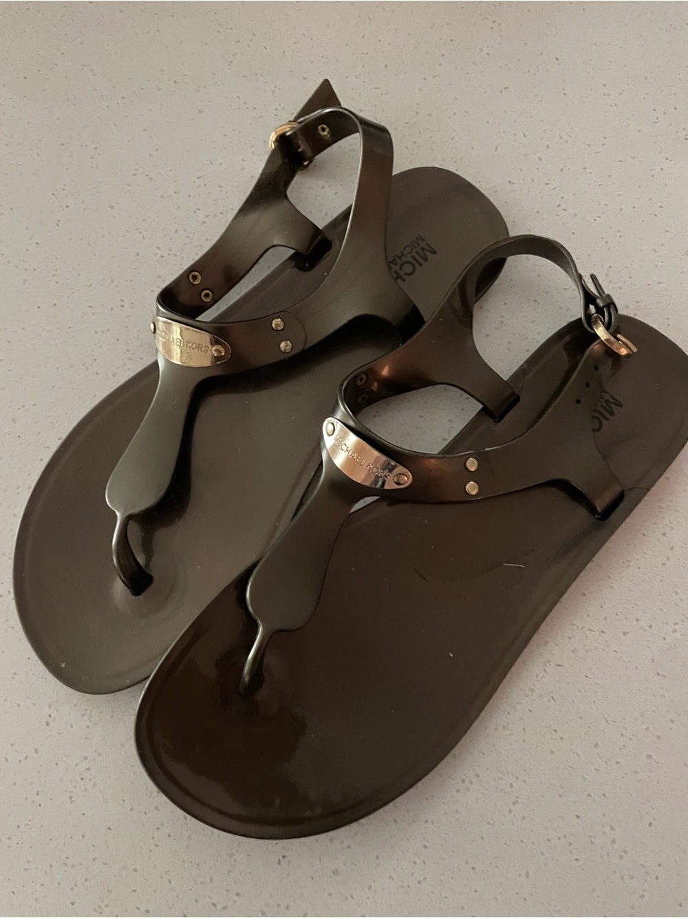 Michael Kors Black Jelly T-Strap Sandals with Gold Logo Plate
